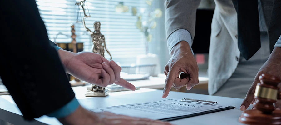 Luxury fashion partners signing contract with legal counsel.